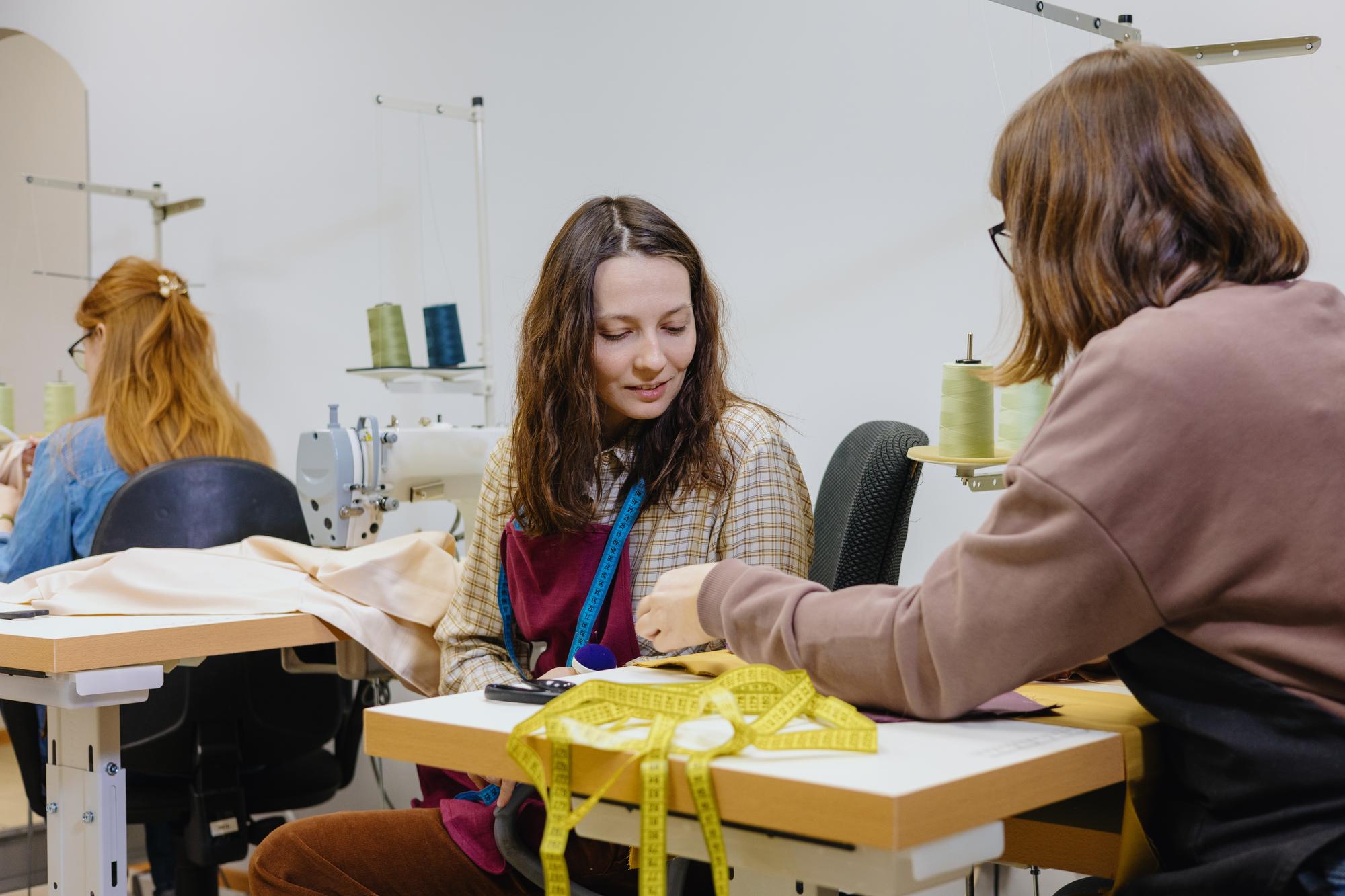 Teacher demonstrating satin stitch in bright studio